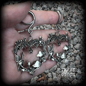 These awesome antique silver forest punk earrings are gorgeous!! 
Featuring a heart of ferns with snails, mushrooms and spiders, these earrings weigh approx 11 grams each, and measure in at just over 7cms from tip to tip.

This pair has been made on 6 gauge (4mm) gauge surgical steel full curls, to be worn in stretched lobes.