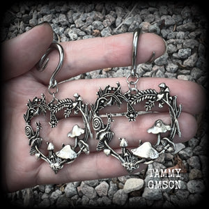 These awesome antique silver forest punk earrings are gorgeous!! 
Featuring a heart of ferns with snails, mushrooms and spiders, these earrings weigh approx 11 grams each, and measure in at just over 7cms from tip to tip.

This pair has been made on 6 gauge (4mm) gauge surgical steel full curls, to be worn in stretched lobes.