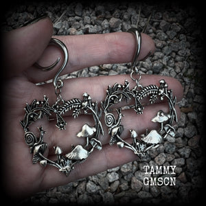 These awesome antique silver forest punk earrings are gorgeous!! 
Featuring a heart of ferns with snails, mushrooms and spiders, these earrings weigh approx 11 grams each, and measure in at just over 7cms from tip to tip.

This pair has been made on 6 gauge (4mm) gauge surgical steel full curls, to be worn in stretched lobes.