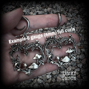 These awesome antique silver forest punk earrings are gorgeous!! 
Featuring a heart of ferns with snails, mushrooms and spiders, these earrings weigh approx 11 grams each, and measure in at just over 7cms from tip to tip.

This pair has been made on 6 gauge (4mm) gauge surgical steel full curls, to be worn in stretched lobes.