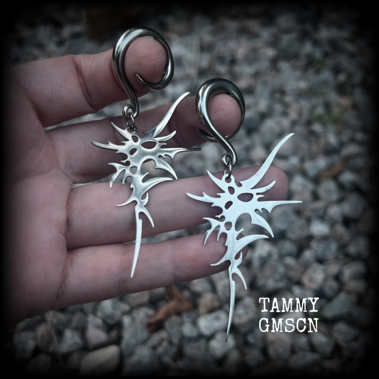 These awesome punk rock earrings feature stainless steel cybersigils, weighing approx 9 grams a piece, and nice and dangly on 8cms from tip to tip.  This pair has been made on 2 gauge (6mm) surgical steel full curl hooks, suitable for stretched lobes.