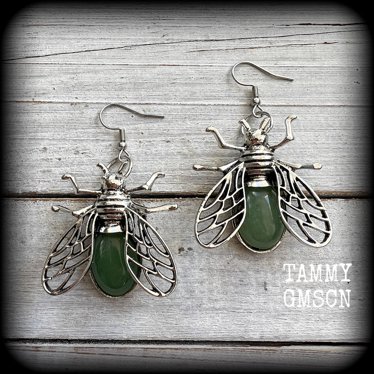 These unique earrings feature beautiful antique silver insect pendants, with gorgeous green polished aventurine cabachons.

These earrings are nice and dangly, measuring just on 6cms from tip to tip, and weighing 12 grams each.

This pair have been made with stainless steel french hooks, suitable for pierced ears.