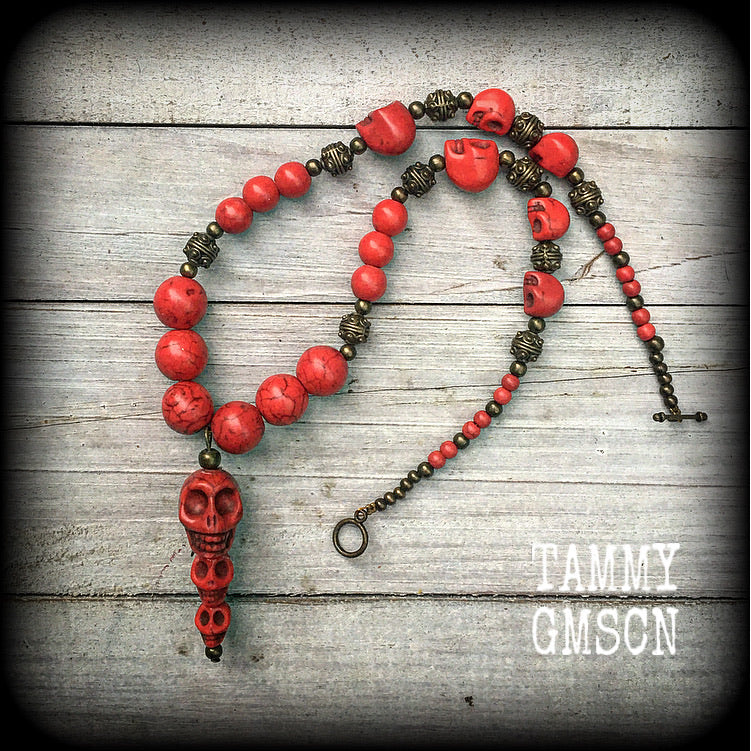 This striking necklace is one of the simpler pieces from our 'Kali Maa' range, featuring blood red stone skulls and antique bronze ornate tribal beads, with a skull stack pendant measuring 5.5cms from tip to tip.

This necklace measures 42cms from tip to tip when laid flat and fastens with an antique bronze toggle clasp.

