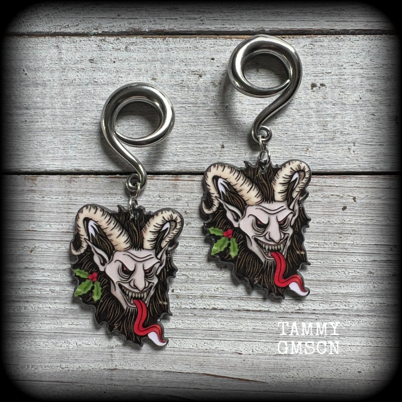 Featuring lightweight acrylic Krampus charms, these awesome gauged earrings weigh approx 10 grams each, and are lovely and dangly at just on 7cms from tip to tip.

This pair has been made on 2 gauge (6mm) surgical steel full curl hooks, to be worn in stretched lobes.

❄️🎄☃️ Find all of our festive and seasonal earrings in our Samain-Yule-Ostara range, and if you dont see what you are looking for please get in touch!