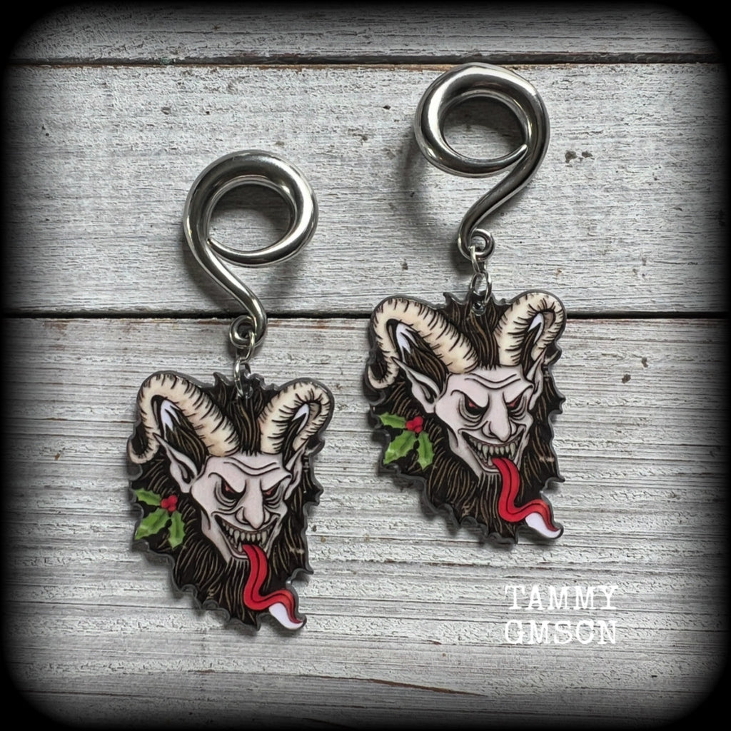 Featuring lightweight acrylic Krampus charms, these awesome gauged earrings weigh approx 10 grams each, and are lovely and dangly at just on 7cms from tip to tip.

This pair has been made on 2 gauge (6mm) surgical steel full curl hooks, to be worn in stretched lobes.

❄️🎄☃️ Find all of our festive and seasonal earrings in our Samain-Yule-Ostara range, and if you dont see what you are looking for please get in touch!