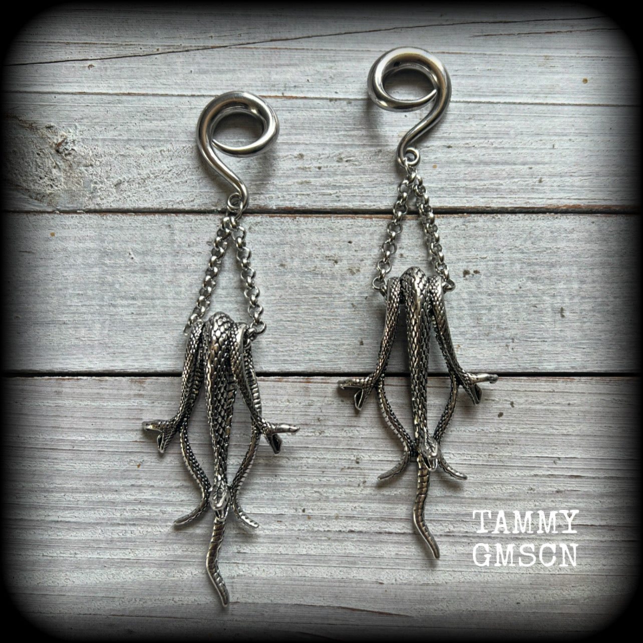 Featuring three gorgeous dangly antique silver snakes, these ear hangers are nice and dangly measuring 12.5cm from tip to tip, and weighing approx 25 grams each.

This pair has been made on 2 gauge (6mm) surgical steel full curl hooks, suitable for stretched lobes.
