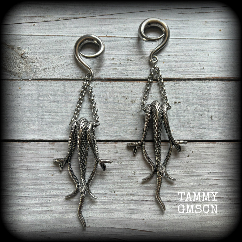 Featuring three gorgeous dangly antique silver snakes, these ear hangers are nice and dangly measuring 12.5cm from tip to tip, and weighing approx 25 grams each.

This pair has been made on 2 gauge (6mm) surgical steel full curl hooks, suitable for stretched lobes.
