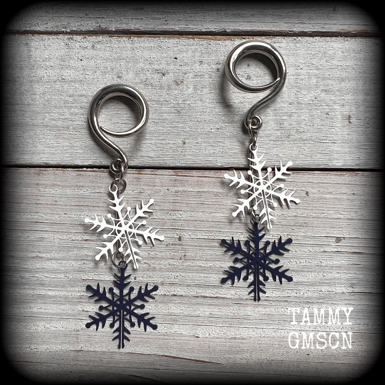 Featuring delicate white and navy blue snowflake charms, these earrings are super lightweight, weighing approx 4 grams each, and are lovely and dangly at just under 8cms from tip to tip.

This pair has been made on 6 gauge (4mm) surgical steel full curl hooks, suitable for stretched lobes.