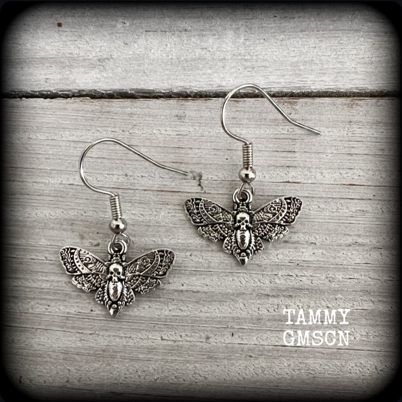 These petite antique silver Deathshead moth earrings feature a gorgeous gothic deathshead moth charm measuring just on 3cms, and weigh only a gram or two each.

This pair has been made on stainless steel french hooks, for pierced ears.