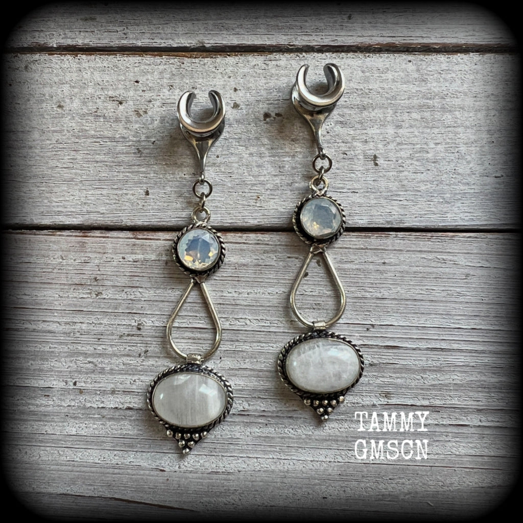 This pair of Rainbow moonstone gauged earrings feature gorgeous gemstones in a beautiful boho antique silver setting, lovely and dangly measuring 7.5cms from tip to tip, and weighing approx 6 grams each.

These earrings have been made on 0 gauge (8mm) surgical steel cradles, to be worn in stretched lobes.