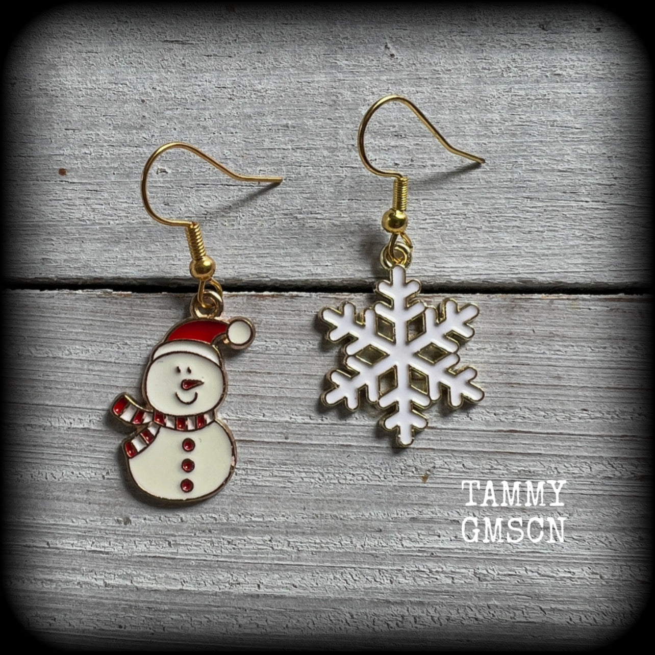 These adorable earrings feature a cute little frosty snowman with gorgeous white snowflakes, measuring just on 4cms and weighing only a few grams each. 

This pair has been made on antique gold french hooks, for pierced ears.
