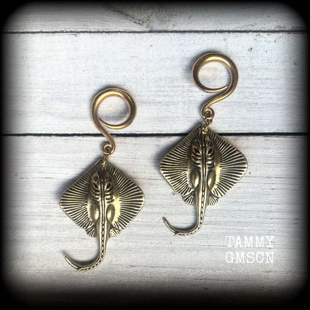 🔥 Symbolically, the stingray embodies calmness under pressure, self-defense, and navigating life's challenges with strength and balance.  

These awesome ear hangers feature a pair of brass sting rays, measuring just on 7cms from tip to tip, and weighing approx 17 grams each.

This pair has been made on 6 gauge (4mm) surgical steel full curls, suitable for stretched lobes.
