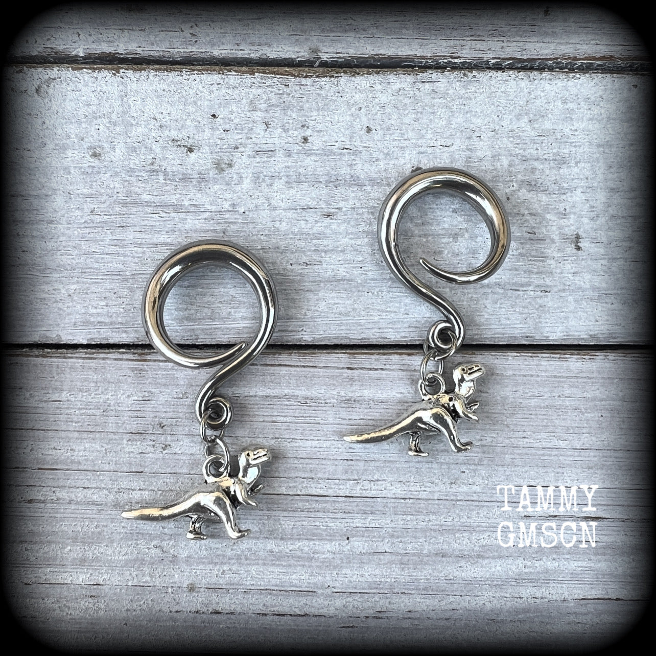 These adorable antique silver Tyrannosaurus rex gauged earrings are nice and light weight at 5 grams a piece, and nice and dangly at 4 cms from tip to tip..

This pair has been made on 6 gauge (4mm) surgical steel full curl hooks, to be worn in stretched lobes.