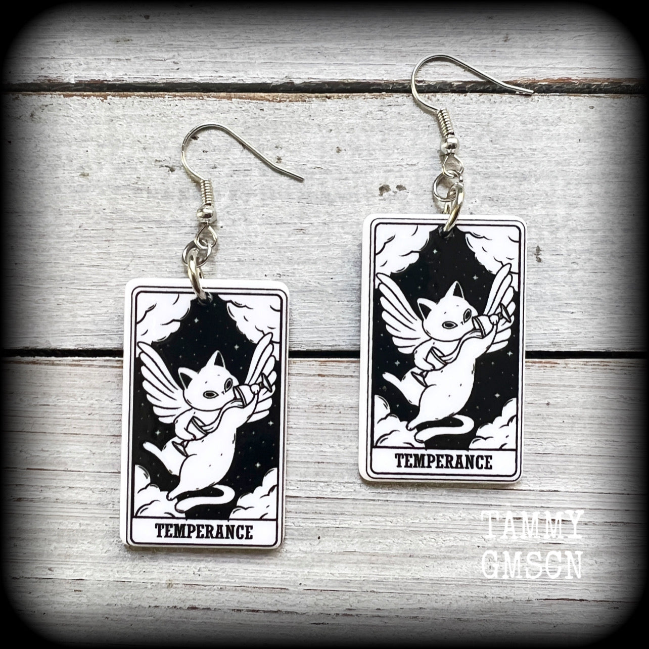 These adorable lightweight acrylic cat tatot card earrings feature 'Temperance' tarot cards, weighing only a few grams each, and measure approx 5cms from tip to tip.

This pair has been made with stainless steel french hooks, for pierced ears.

🐈‍⬛ 🔮We stock these cuties in every major arcana card. If you want to mix and match please just ask!