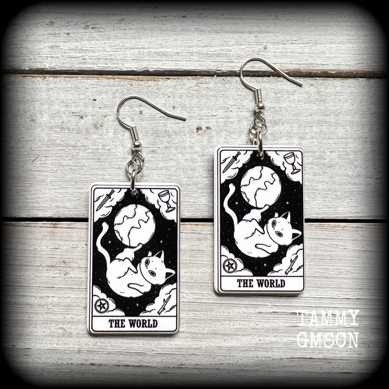 These adorable lightweight acrylic tarot card earrings feature ‘The World’ cat tarot cards, weighing only a few grams each, and measuring approx 5cms from tip to tip.

This pair has been made with stainless steel french hooks, for pierced ears.

🐈‍⬛ 🔮We stock these cuties in every major arcana card. If you want to mix and match please just ask!