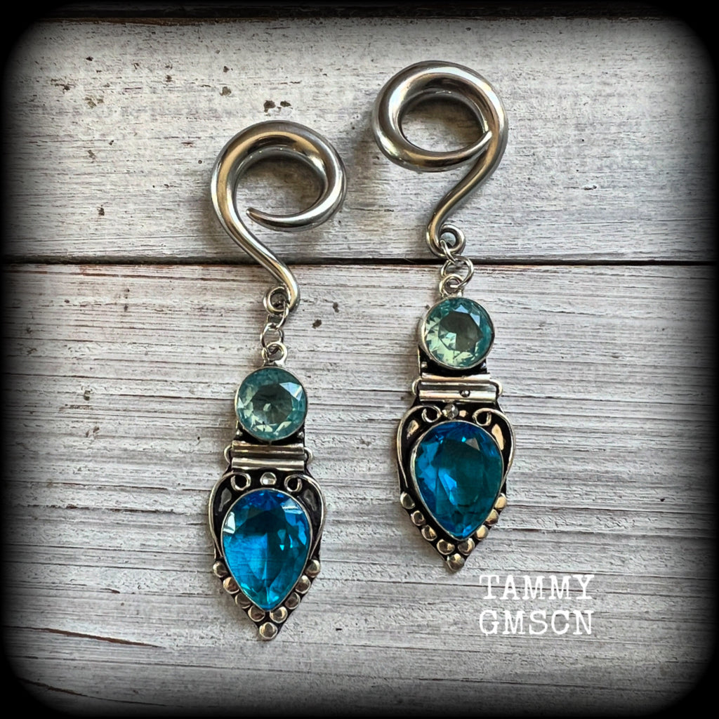 These gorgeous gauged earrings feature facet ocean blue topaz and quartz gemstones in a beautifully boho antique silver setting, lovely and dangly at approx 7.5cms from tip to tip, and not too heavy at only 12 grams each.

These earrings have been made on 2 gauge (6mm) surgical steel full curl hooks, to be worn in stretched lobes.
