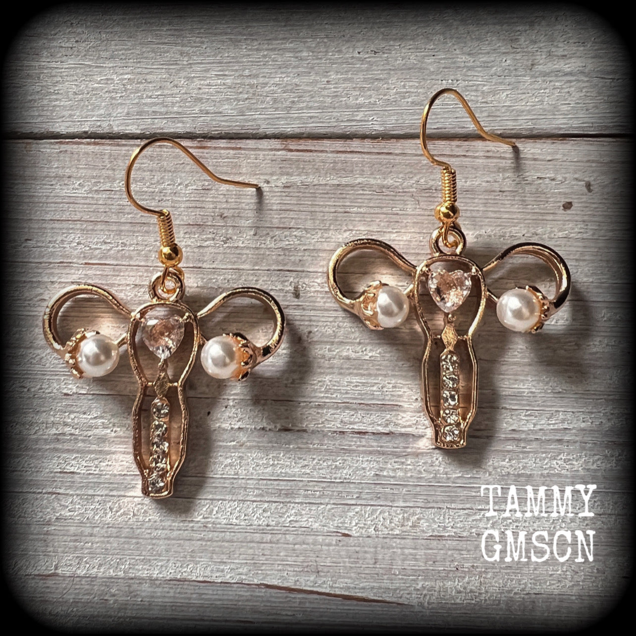 These earrings feature champagne gold tone uterus charms with faux pearl ovaries, encrusted with faux diamonds.
These are nice and lightweight (weighing only a few grams each), and measure just under 5cms from tip to tip.
This pair have been made on antique gold french hooks, for pierced ears.