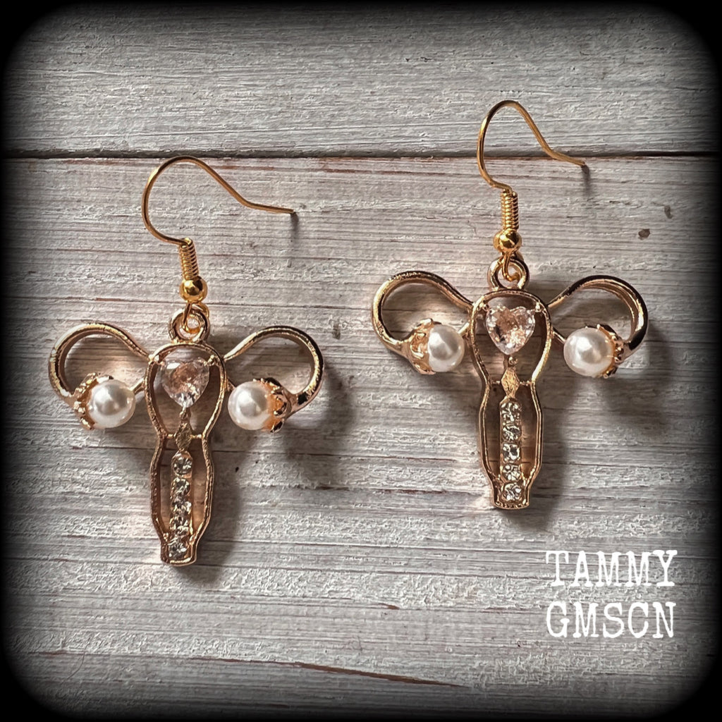 These earrings feature champagne gold tone uterus charms with faux pearl ovaries, encrusted with faux diamonds.
These are nice and lightweight (weighing only a few grams each), and measure just under 5cms from tip to tip.
This pair have been made on antique gold french hooks, for pierced ears.