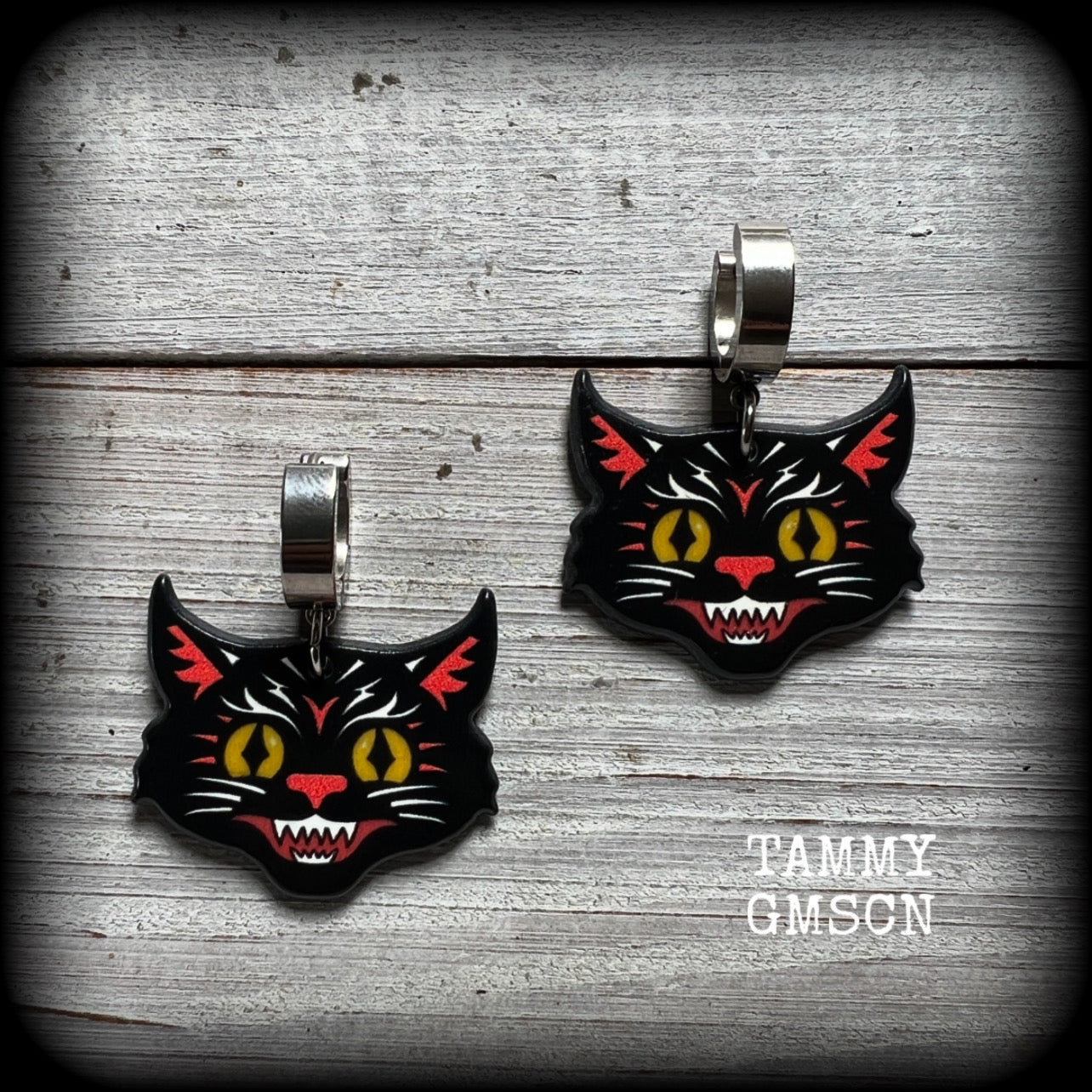 These awesome Halloween earrings feature classic fiesty black cat acrylic charms, are nice and dangly, measuring just on 4 cms from tip to tip and weighing approx 3 grams each, super light weight.

This pair has been made with stainless steel huggie ear cuffs, to be worn in pierced ears.

🎃 Find all of our festive and seasonal earrings in our Samain-Yule-Ostara range, and if you dont see what you are looking for please get in touch!