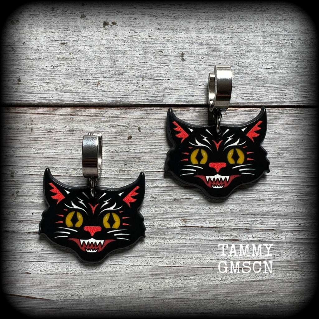 These awesome Halloween earrings feature classic fiesty black cat acrylic charms, are nice and dangly, measuring just on 4 cms from tip to tip and weighing approx 3 grams each, super light weight.

This pair has been made with stainless steel huggie ear cuffs, to be worn in pierced ears.

🎃 Find all of our festive and seasonal earrings in our Samain-Yule-Ostara range, and if you dont see what you are looking for please get in touch!