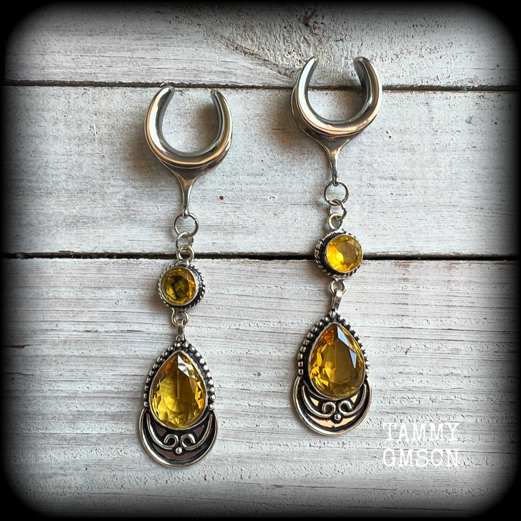 Featuring gorgeous golden yellow cutrine gemstone in a beautiful boho antique silver setting, these earrings measure just over 8cms from tip to tip, and weigh approx 11 grams each.

This pair have been made on 5/8” gauge (16mm) surgical steel full curl hooks, suitable for stretched lobes.
