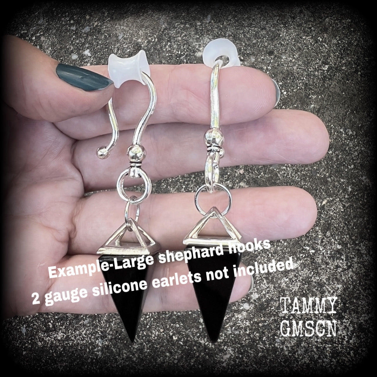 This is a pair of gorgeous pitch black onyx gemstone earrings, not too heavy at approx 10 grams a piece, and measuring just on 7cms from tip to tip.

This pair has been made with large antique silver shephards hooks, to be worn through silicone earlets in stretched lobes from 2 gauge (6mm).