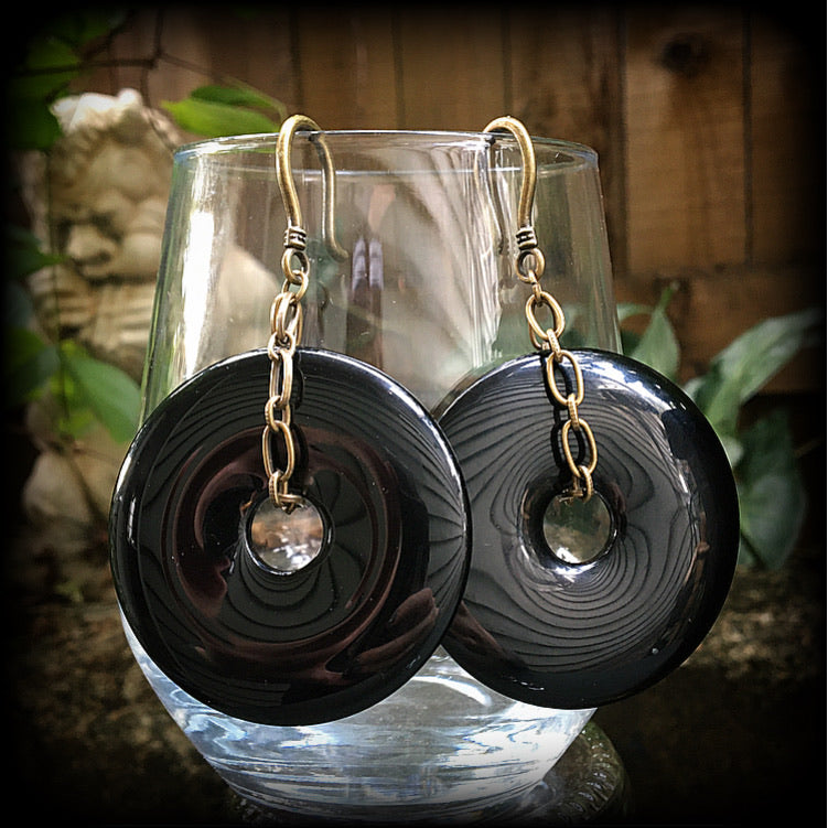 Black obsidian and antique bronze earrings measuring 9cms from tip to tip, weighing approx. 27 grams a piece.
This pair have been made with small antique bronze shephards hooks, to be worn through earlets in stretched lobes from 8 gauge (3mm).