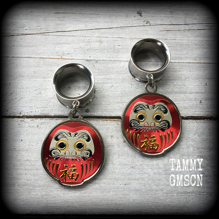 Red daruma These gorgeous tunnel dangles feature stainless steel red daruma dolls, weighing approx 10 grams each and measuring approx 5.5cms from tip to tip.

This pair have been made with 9/16” gauge (14mm) surgical steel screw fit earlets.