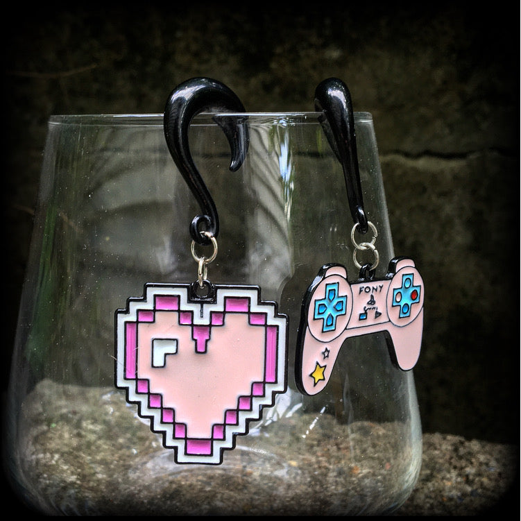 These awesome gamer girl gauged earrings feature a pink pixel heart with matching pink hand control, measuring just over 6cms from tip to tip and weighing 10 grams a piece.

This pair has been made on 2 gauge (6mm) surgical steel half curl hooks, suitable for stretched lobes.