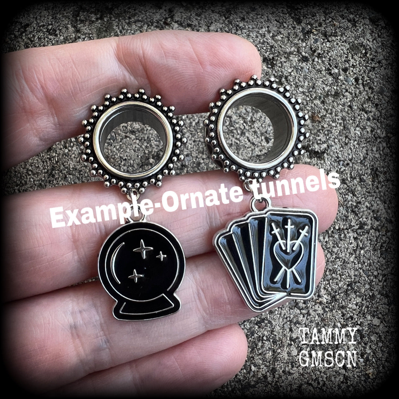 These gorgeous spooky tunnel dangles feature cute black enamel crystal ball and tarot card charms, are nice and lightweight-weighing only 7 grams each and measure 5cms from tip to tip.

This pair have been made on 5/8" (16mm) gauge ornate surgical steel screw fit tunnels.