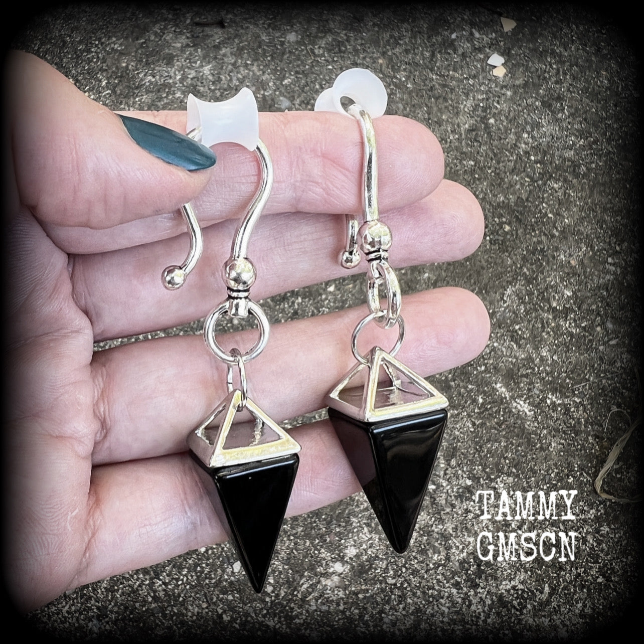 This is a pair of gorgeous pitch black onyx gemstone earrings, not too heavy at approx 10 grams a piece, and measuring just on 7cms from tip to tip.

This pair has been made with large antique silver shephards hooks, to be worn through silicone earlets in stretched lobes from 2 gauge (6mm).