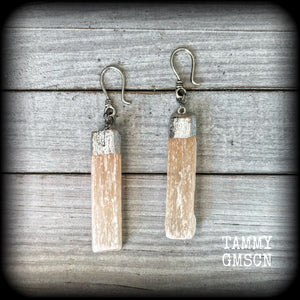 Featuring beautiful dusty pink selenite pieces, these earrings are nice and dangly, measuring approx 9cms from tip to tip, and not too heavy weighing in at approx 15 grams each.

This pair has been made on small antique silver shephard hooks to be worn through silicone earlets from 8 gauge (3mm).