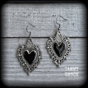 These gorgeous antique silver and enamel 'Black heart' sacred heart earrings are nice and lightweight at just 5 grams a piece and measure just on 6cms from tip to tip.

This pair has been made on stainless steel french hooks to be worn through pierced ears.