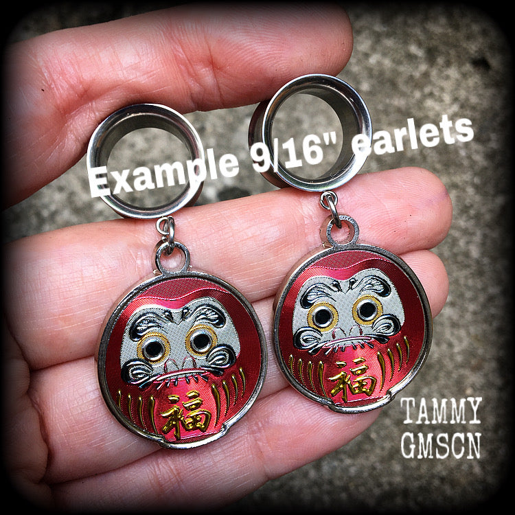 14mm tunnel earrings  These gorgeous tunnel dangles feature stainless steel red daruma dolls, weighing approx 10 grams each and measuring approx 5.5cms from tip to tip.

This pair have been made with 9/16” gauge (14mm) surgical steel screw fit earlets.