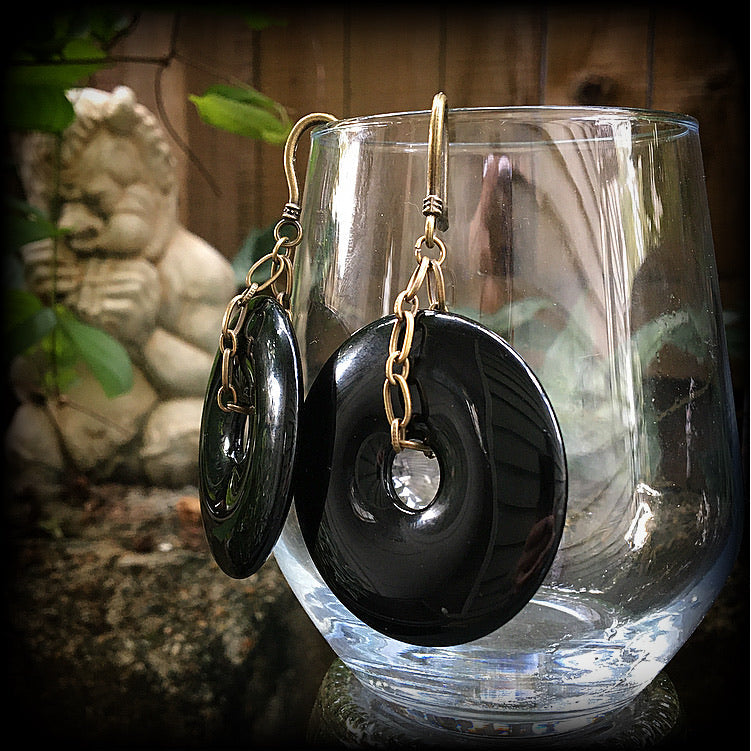 Black obsidian and antique bronze earrings measuring 9cms from tip to tip, weighing approx. 27 grams a piece.
This pair have been made with small antique bronze shephards hooks, to be worn through earlets in stretched lobes from 8 gauge (3mm).