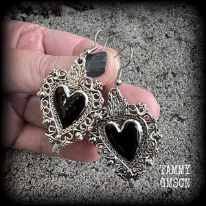 These gorgeous antique silver and enamel 'Black heart' sacred heart earrings are nice and lightweight at just 5 grams a piece and measure just on 6cms from tip to tip.

This pair has been made on stainless steel french hooks to be worn through pierced ears.