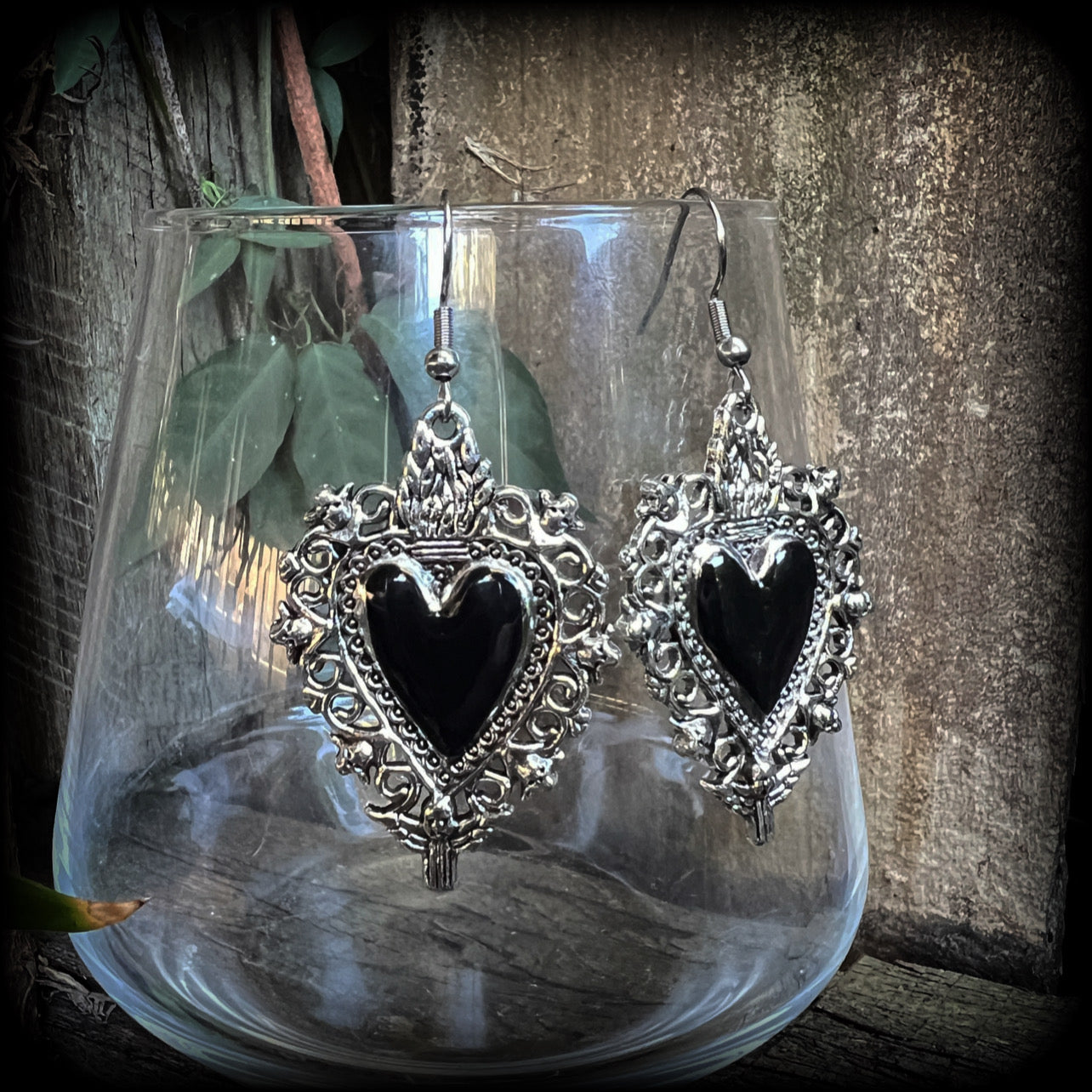 These gorgeous antique silver and enamel 'Black heart' sacred heart earrings are nice and lightweight at just 5 grams a piece and measure just on 6cms from tip to tip.

This pair has been made on stainless steel french hooks to be worn through pierced ears.