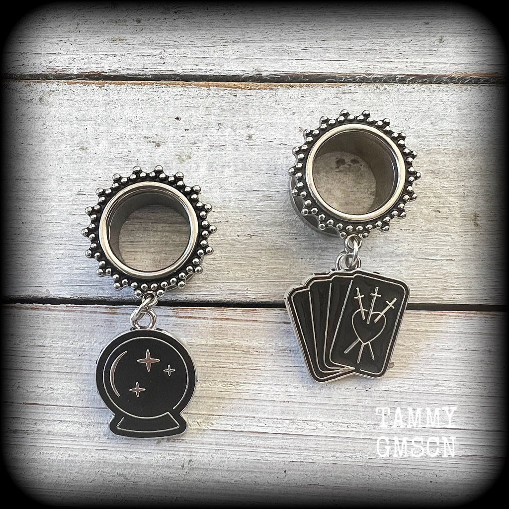 These gorgeous spooky tunnel dangles feature cute black enamel crystal ball and tarot card charms, are nice and lightweight-weighing only 7 grams each and measure 5cms from tip to tip.

This pair have been made on 5/8" (16mm) gauge ornate surgical steel screw fit tunnels.