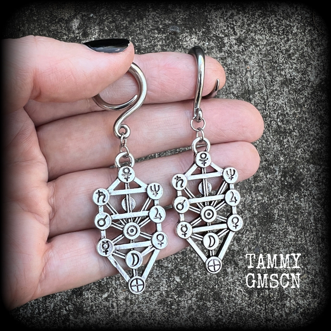 Our 'Tree of Life' gauged earrings feature stunning Kabalistic Tree of Life charms complete with sephiroth symbols. These earrings and are nice and dangly at just on 7cms, and weigh 8 grams a piece.
This pair has been made on 6 gauge (4mm) surgical steel full curl hooks, to be worn in stretched lobes.