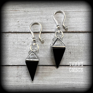 This is a pair of gorgeous pitch black onyx gemstone earrings, not too heavy at approx 10 grams a piece, and measuring just on 7cms from tip to tip.

This pair has been made with large antique silver shephards hooks, to be worn through silicone earlets in stretched lobes from 2 gauge (6mm).