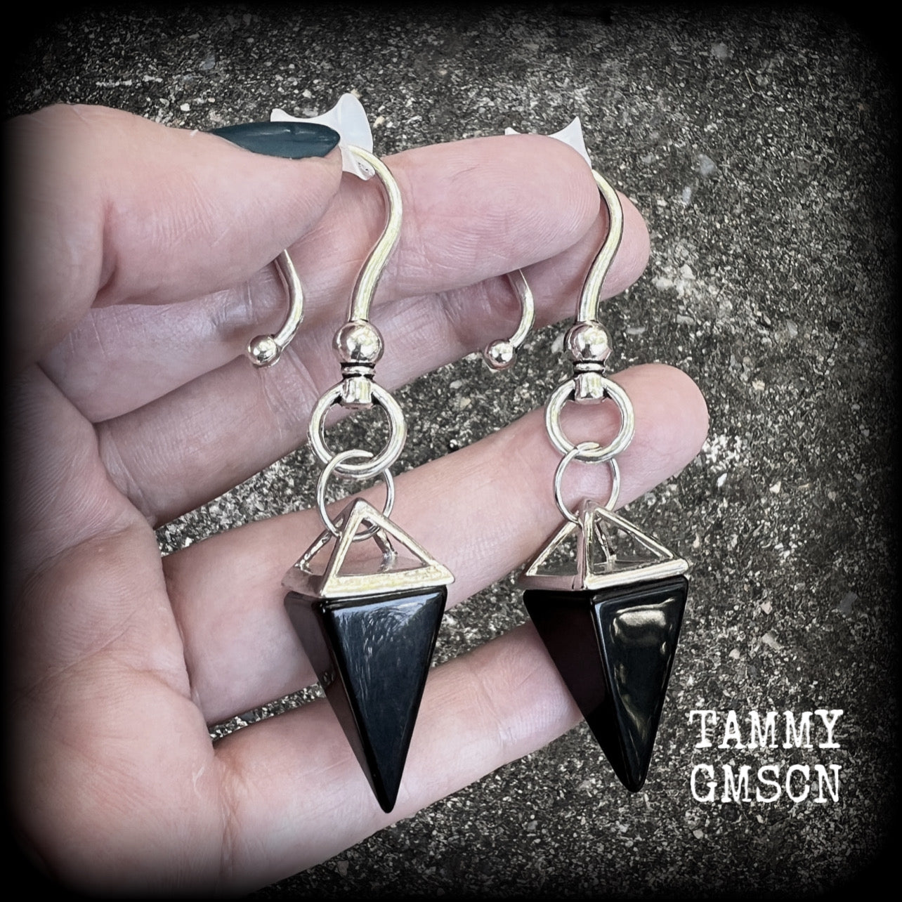 This is a pair of gorgeous pitch black onyx gemstone earrings, not too heavy at approx 10 grams a piece, and measuring just on 7cms from tip to tip.

This pair has been made with large antique silver shephards hooks, to be worn through silicone earlets in stretched lobes from 2 gauge (6mm).