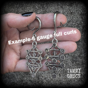 Our 'Tree of Life' gauged earrings feature stunning Kabalistic Tree of Life charms complete with sephiroth symbols. These earrings and are nice and dangly at just on 7cms, and weigh 8 grams a piece.
This pair has been made on 6 gauge (4mm) surgical steel full curl hooks, to be worn in stretched lobes.