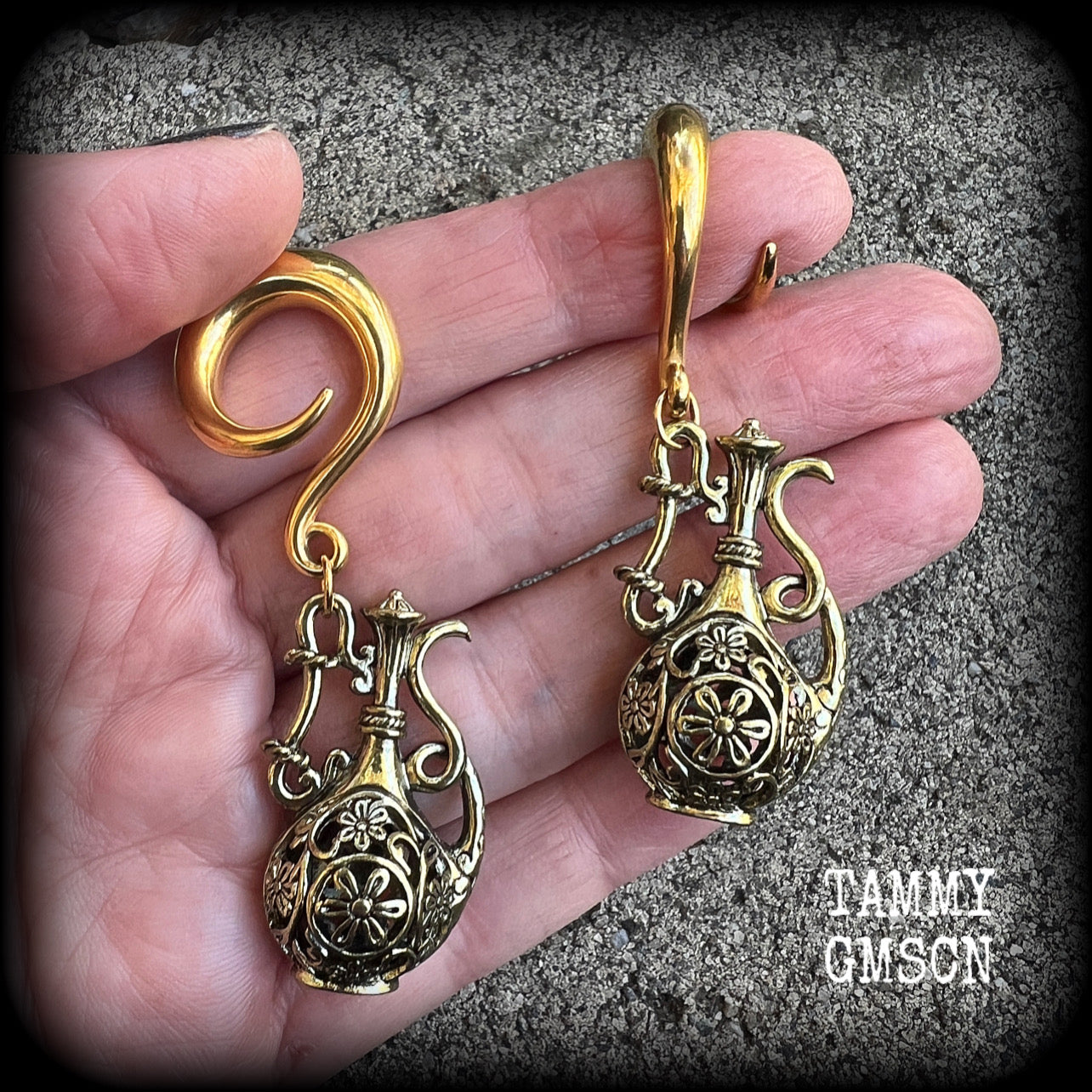 Inspired by the Star sign Aquarius-the water carrier, these gorgeous brass gauged earrings feature an ornate water jug, measuring 7 cms from tip to tip, and weighing approx 13 grams a piece.

This pair of earrings have been made on 2 gauge (6mm) surgical steel full curl hooks, suitable for stretched lobes.