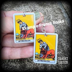 These classic Major Arcana earrings feature a lightweight plastic 'Strength' tarot card charm, measuring just under 6cms from tip to tip.

This pair has been made with stainless steel french hooks, suitable for pierced ears.