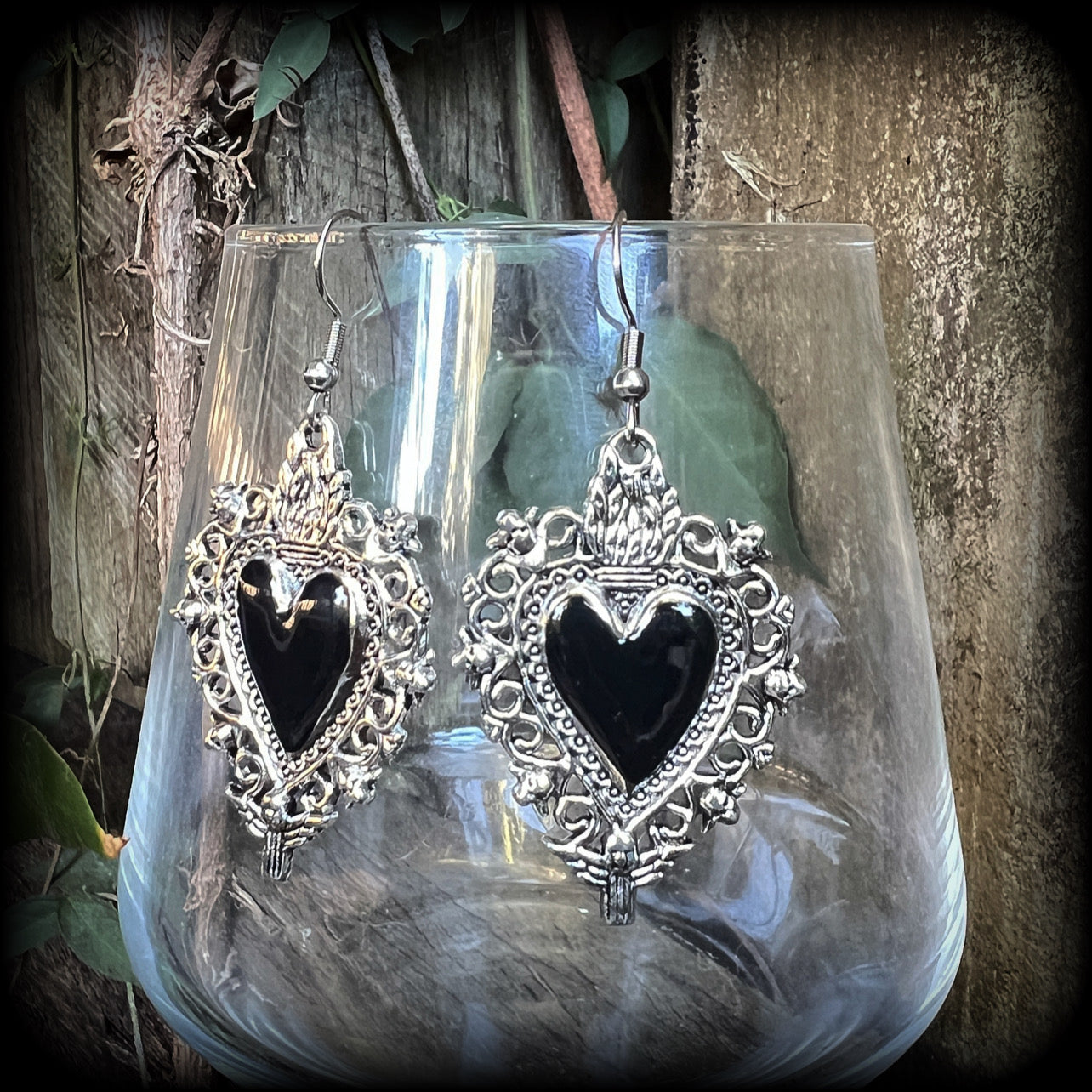 These gorgeous antique silver and enamel 'Black heart' sacred heart earrings are nice and lightweight at just 5 grams a piece and measure just on 6cms from tip to tip.

This pair has been made on stainless steel french hooks to be worn through pierced ears.