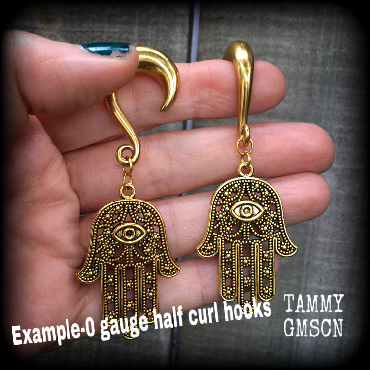 These awesome antique gold 'Hamsa hand' gauged earrings weigh approx 15 grams each, and are nice and dangly,hanging just on 8cms from tip to tip.
This pair have been made on 0 gauge (8mm) titanium coated surgical steel half curl hooks, to be worn in stretched lobes.