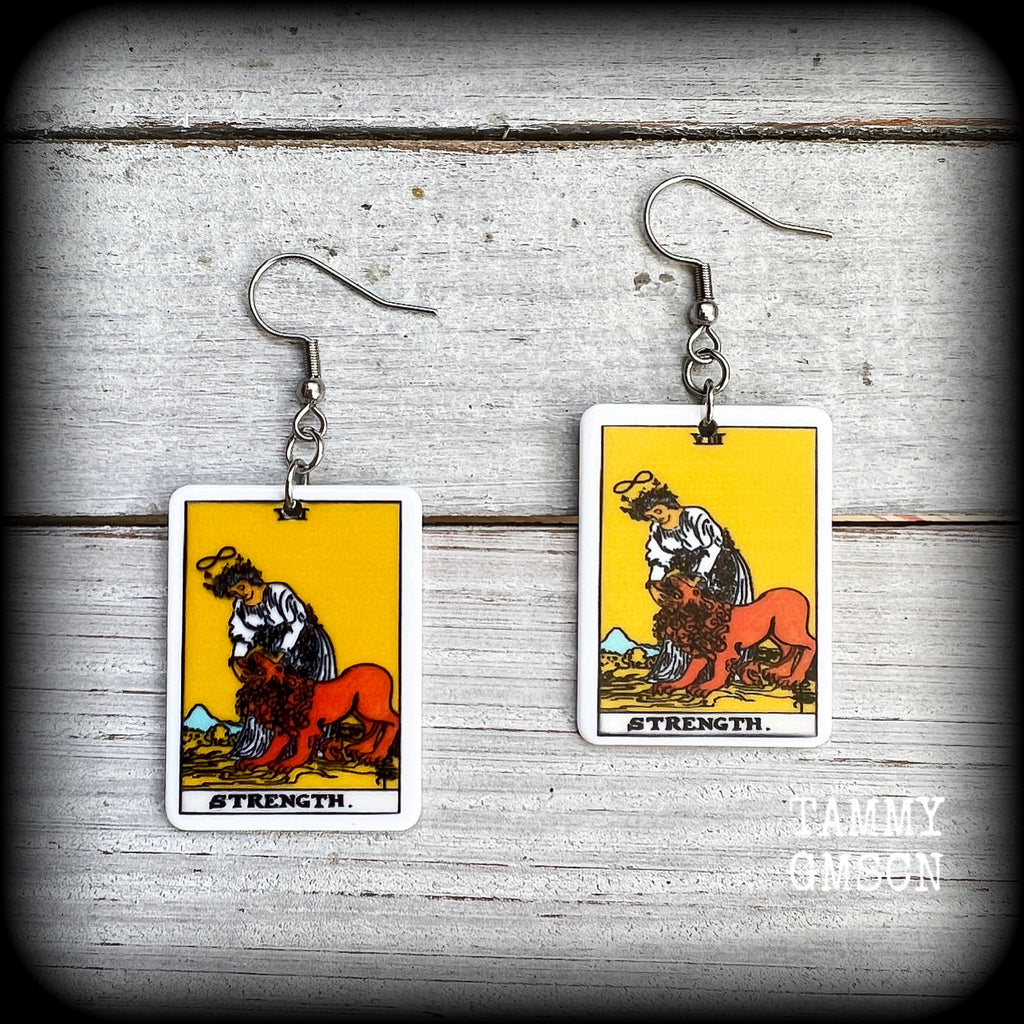 These classic Major Arcana earrings feature a lightweight plastic 'Strength' tarot card charm, measuring just under 6cms from tip to tip.

This pair has been made with stainless steel french hooks, suitable for pierced ears.
