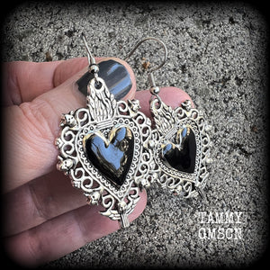 These gorgeous antique silver and enamel 'Black heart' sacred heart earrings are nice and lightweight at just 5 grams a piece and measure just on 6cms from tip to tip.

This pair has been made on stainless steel french hooks to be worn through pierced ears.