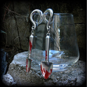 Our awesome ‘Grave digger’ gauged earrings feature a pair of b l o o d spattered stainless steel shovels weighing in at 24 grams a piece, and are nice and dangly at just over 10cms.

This pair has been made on 0 gauge (8mm) surgical steel full curl hooks, to be worn in stretched lobes.