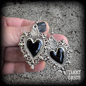 These gorgeous antique silver and enamel 'Black heart' sacred heart earrings are nice and lightweight at just 5 grams a piece and measure just on 6cms from tip to tip.

This pair has been made on stainless steel french hooks to be worn through pierced ears.